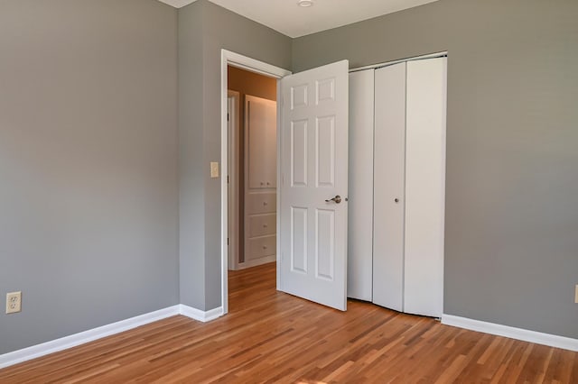 4020 Orleans Ln N, Plymouth, MN 55441 - unfurnished bedroom with light wood-type flooring, baseboards, and a closet