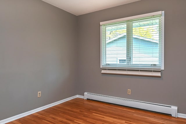 4020 Orleans Ln N, Plymouth, MN 55441 - empty room with a baseboard radiator, baseboards, and wood finished floors