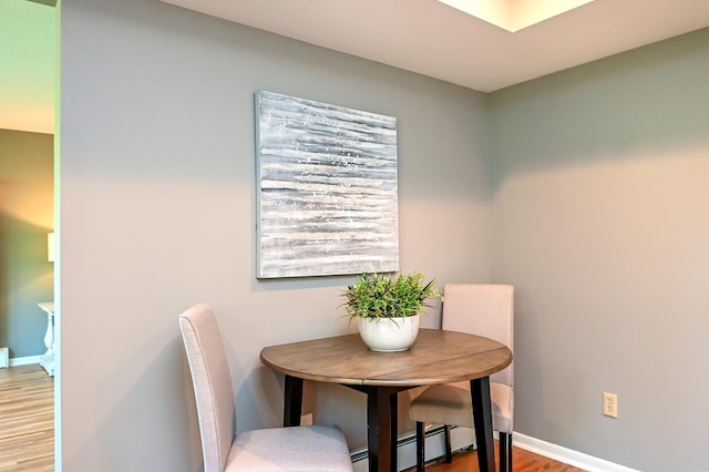 4020 Orleans Ln N, Plymouth, MN 55441 - dining area featuring wood finished floors, baseboards, and baseboard heating