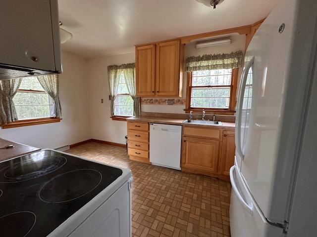 5960 Evergreen Rd, Biwabik Twp, MN 55705 - kitchen with white appliances, a sink, and light countertops