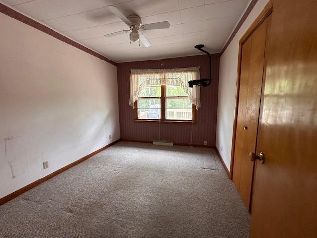 5960 Evergreen Rd, Biwabik Twp, MN 55705 - spare room with light carpet, a ceiling fan, crown molding, and baseboards
