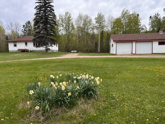 5960 Evergreen Rd, Biwabik Twp, MN 55705 - view of grassy yard with a detached garage