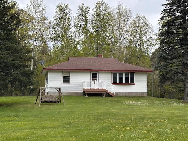 5960 Evergreen Rd, Biwabik Twp, MN 55705 - back of property with a yard, a wooden deck, and a chimney