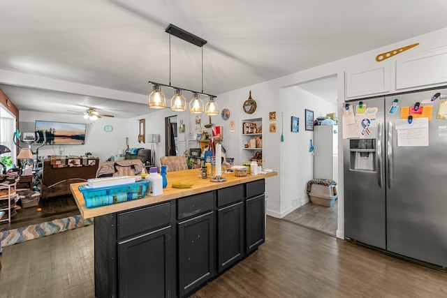 820 6th St, Montevideo, MN 56265 - kitchen featuring stainless steel refrigerator with ice dispenser, dark wood-style floors, a ceiling fan, dark cabinetry, and hanging light fixtures