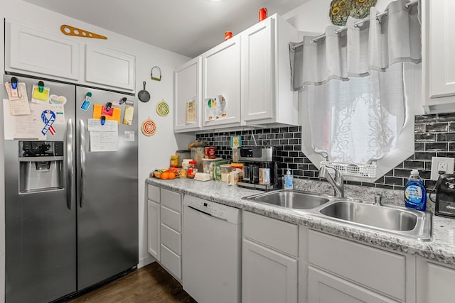 820 6th St, Montevideo, MN 56265 - kitchen featuring stainless steel fridge with ice dispenser, white dishwasher, a sink, white cabinets, and decorative backsplash