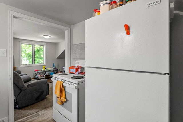 820 6th St, Montevideo, MN 56265 - kitchen with white appliances, light wood finished floors, and light countertops