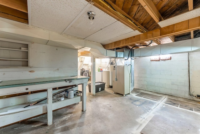 820 6th St, Montevideo, MN 56265 - unfinished basement with heating unit, concrete block wall, washing machine and dryer, and a workshop area