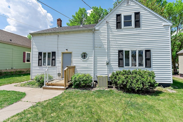 820 6th St, Montevideo, MN 56265 - view of front of property featuring a front yard, central air condition unit, and a chimney