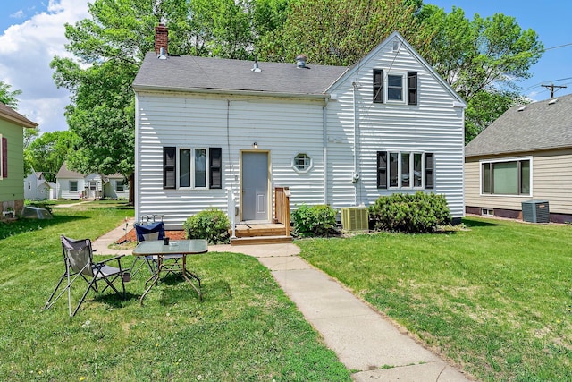 820 6th St, Montevideo, MN 56265 - view of front facade with a front yard, cooling unit, and a chimney