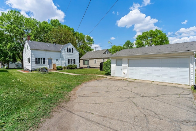 820 6th St, Montevideo, MN 56265 - view of front of home featuring a front lawn, a garage, and a chimney