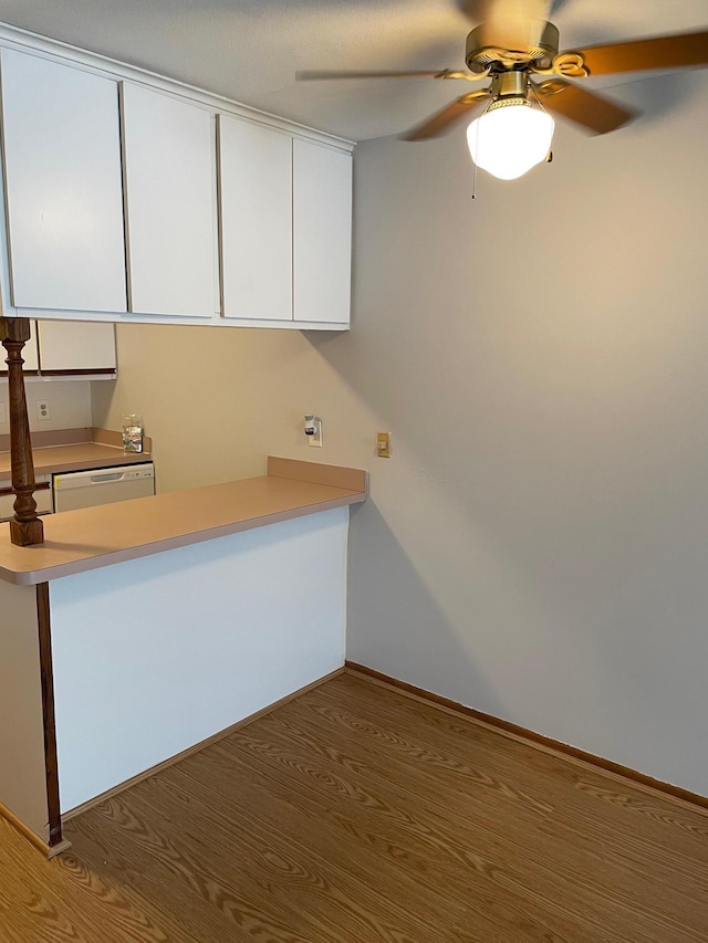 4030 15th Ave S Unit 8C, Minneapolis, MN 55407 - kitchen featuring white cabinetry, a ceiling fan, light countertops, and wood finished floors
