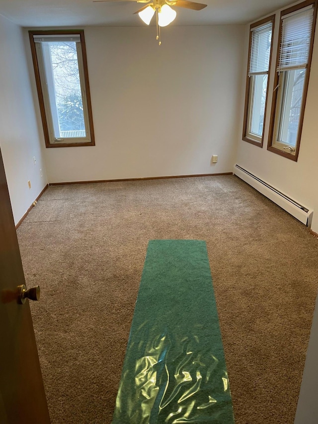 4030 15th Ave S Unit 8C, Minneapolis, MN 55407 - spare room with a baseboard heating unit, carpet, a ceiling fan, and baseboards