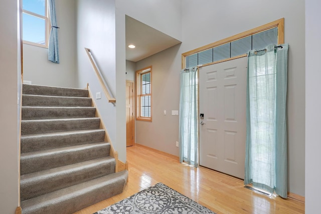 15285 Quinn St NW, Andover, MN 55304 - foyer entrance featuring light wood finished floors, stairway, baseboards, and recessed lighting