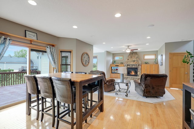 15285 Quinn St NW, Andover, MN 55304 - dining room featuring a fireplace, light wood-style floors, plenty of natural light, recessed lighting, and ceiling fan