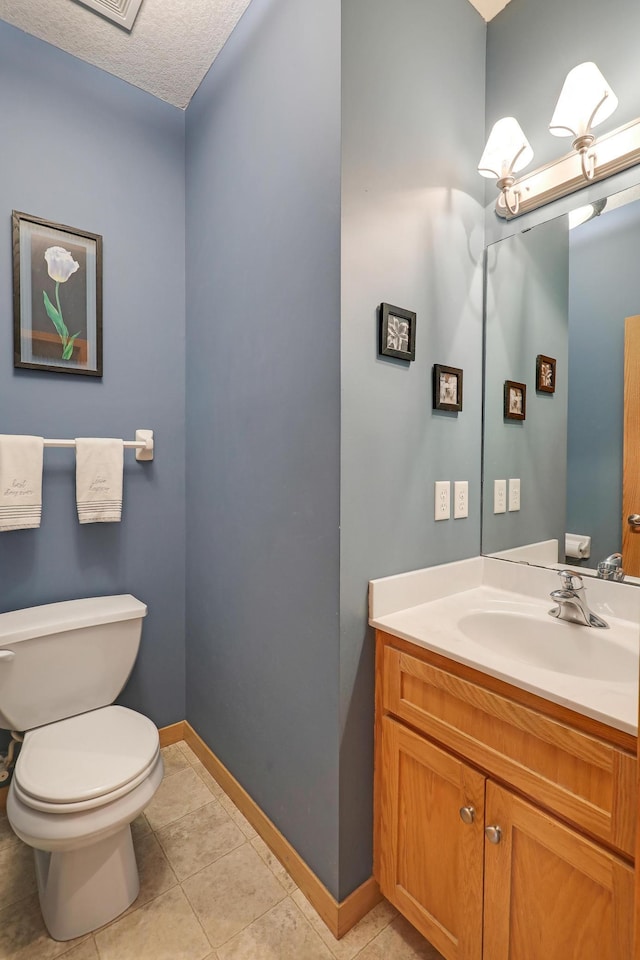 15285 Quinn St NW, Andover, MN 55304 - bathroom featuring toilet, vanity, tile patterned floors, and baseboards