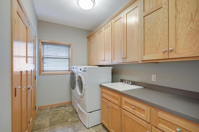 15285 Quinn St NW, Andover, MN 55304 - laundry area featuring cabinet space, washer and clothes dryer, baseboards, and light stone finish floors