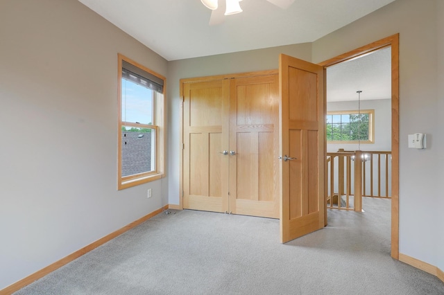 15285 Quinn St NW, Andover, MN 55304 - unfurnished bedroom featuring carpet, baseboards, a closet, and a ceiling fan