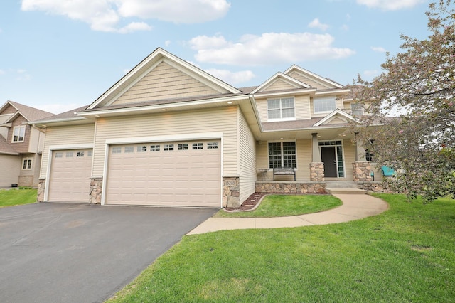 15285 Quinn St NW, Andover, MN 55304 - view of front of house featuring stone siding, a porch, a garage, and driveway