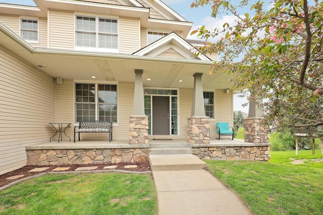 15285 Quinn St NW, Andover, MN 55304 - view of exterior entry featuring covered porch and a lawn