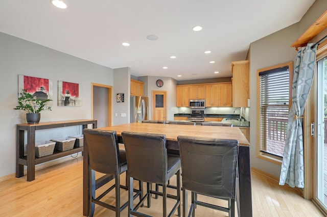 15285 Quinn St NW, Andover, MN 55304 - kitchen with appliances with stainless steel finishes, butcher block counters, light wood-style flooring, recessed lighting, and light brown cabinets