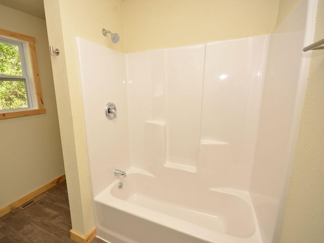 24061 US-71, Park Rapids, MN 56470 - bathroom featuring wood finished floors, baseboards, and shower / bath combination