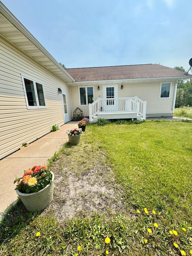 11777 State Highway 11 SE, Baudette, MN 56623 - back of house with a lawn, a deck, and a shingled roof
