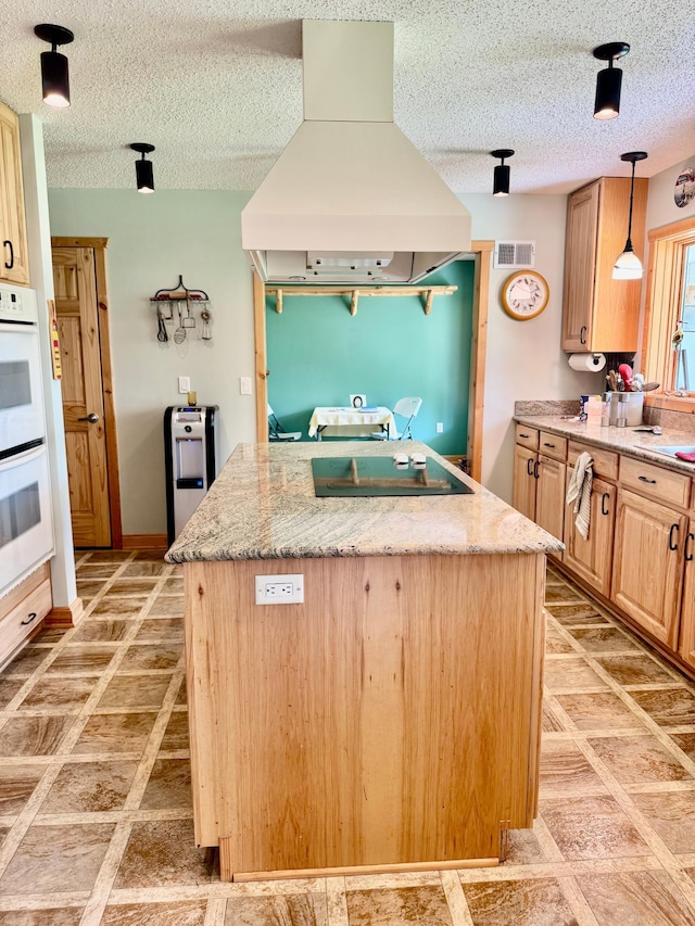 11777 State Highway 11 SE, Baudette, MN 56623 - kitchen with black electric stovetop, premium range hood, white double oven, a kitchen island, and light brown cabinets