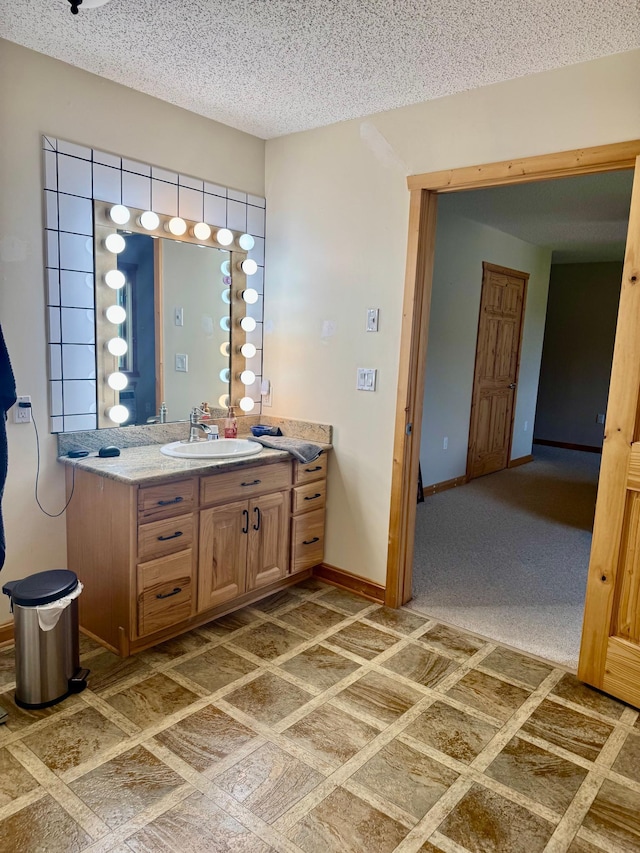 11777 State Highway 11 SE, Baudette, MN 56623 - bathroom with vanity, baseboards, and a textured ceiling
