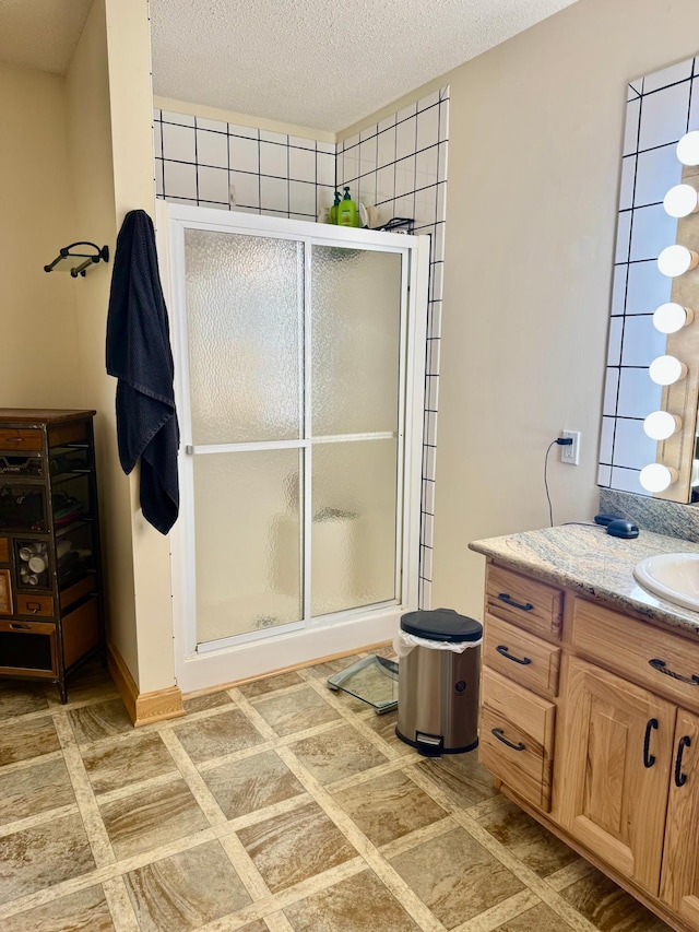 11777 State Highway 11 SE, Baudette, MN 56623 - full bath featuring vanity, a shower stall, and a textured ceiling
