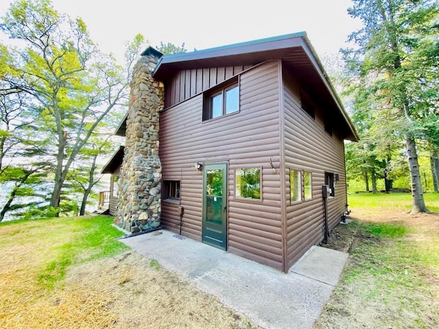 6974 Bankers Dr, Minong, WI 54859 - view of property exterior featuring board and batten siding and faux log siding