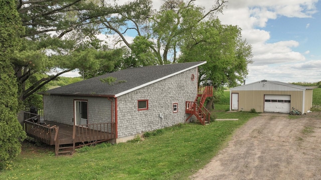 N10221 970th St, Grant Twp, WI 54730 - view of side of property with an outdoor structure, a garage, roof with shingles, a wooden deck, and dirt driveway