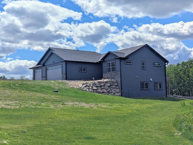 26884 709th St, Lake City, MN 55041 - view of side of home featuring board and batten siding, a yard, stone siding, and an attached garage