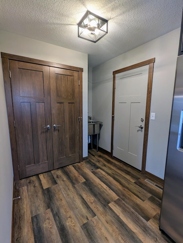 26884 709th St, Lake City, MN 55041 - foyer featuring dark wood-style floors, a textured ceiling, and baseboards