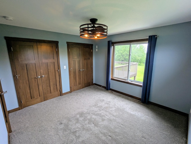 26884 709th St, Lake City, MN 55041 - unfurnished bedroom with multiple closets, light colored carpet, and baseboards