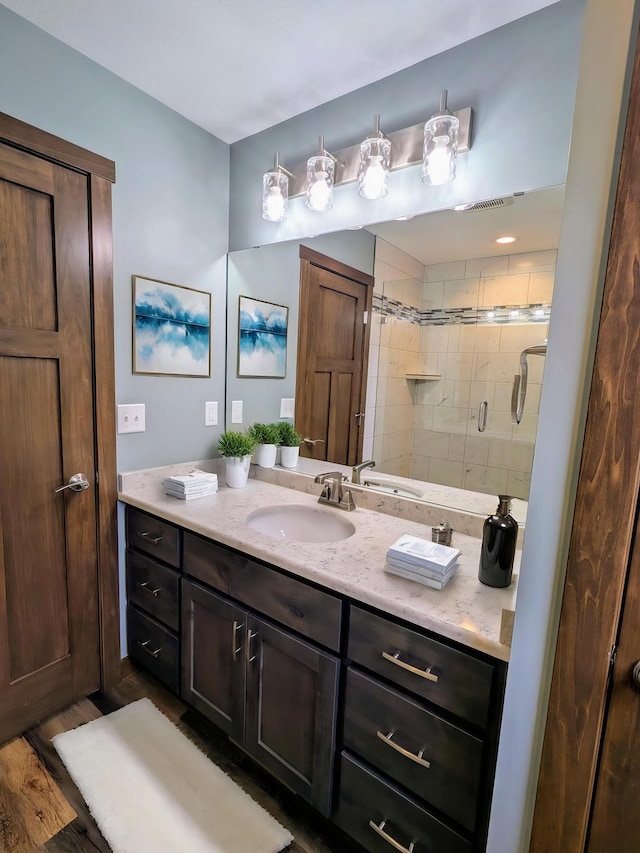 26884 709th St, Lake City, MN 55041 - bathroom with vanity, a shower stall, and wood finished floors