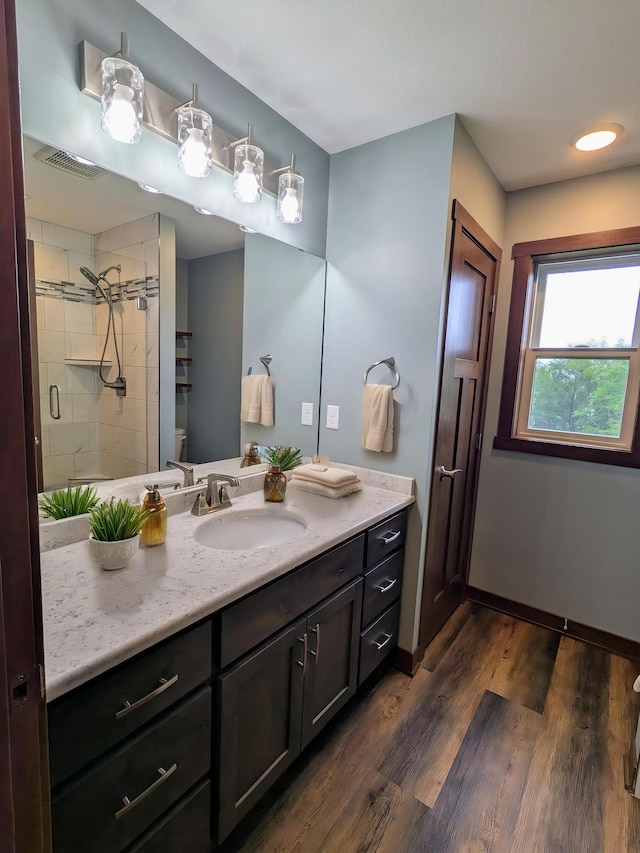 26884 709th St, Lake City, MN 55041 - bathroom with vanity, wood finished floors, a shower stall, toilet, and baseboards