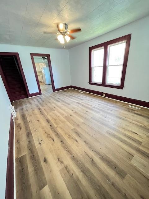 1269 Margaret St, Saint Paul, MN 55106 - unfurnished bedroom featuring wood finished floors, baseboards, a ceiling fan, and freestanding refrigerator