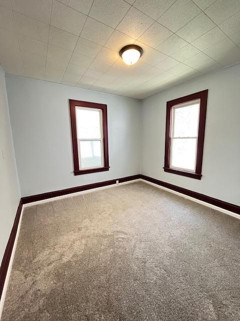 1269 Margaret St, Saint Paul, MN 55106 - unfurnished room with healthy amount of natural light, carpet flooring, and baseboards