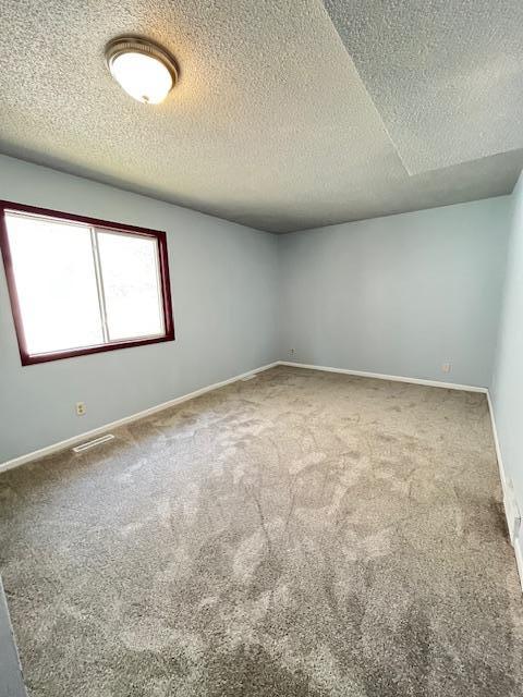 1269 Margaret St, Saint Paul, MN 55106 - carpeted spare room featuring a textured ceiling and baseboards