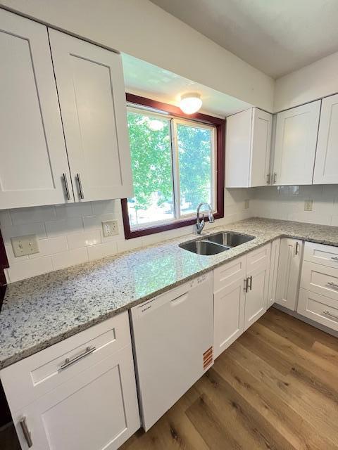 1269 Margaret St, Saint Paul, MN 55106 - kitchen with white dishwasher, a sink, dark wood-style flooring, and white cabinetry