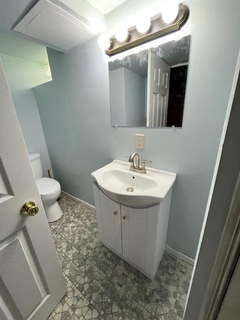 1269 Margaret St, Saint Paul, MN 55106 - bathroom featuring vanity, toilet, and baseboards
