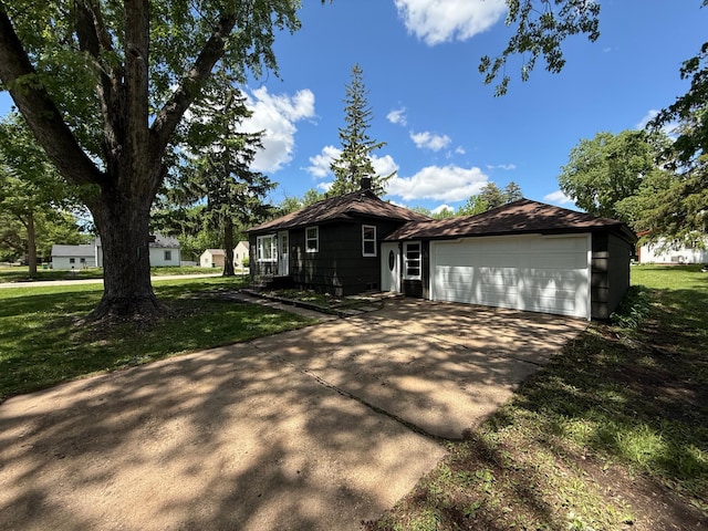 446 Darwin St, Litchfield, MN 55355 - view of front of property featuring a front lawn, an attached garage, and concrete driveway