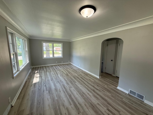 446 Darwin St, Litchfield, MN 55355 - unfurnished room with arched walkways, baseboards, wood finished floors, and ornamental molding