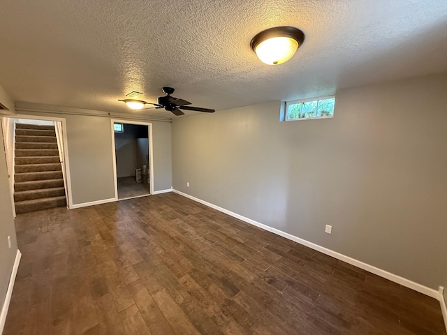 446 Darwin St, Litchfield, MN 55355 - unfurnished bedroom featuring baseboards, dark wood finished floors, a textured ceiling, and two closets