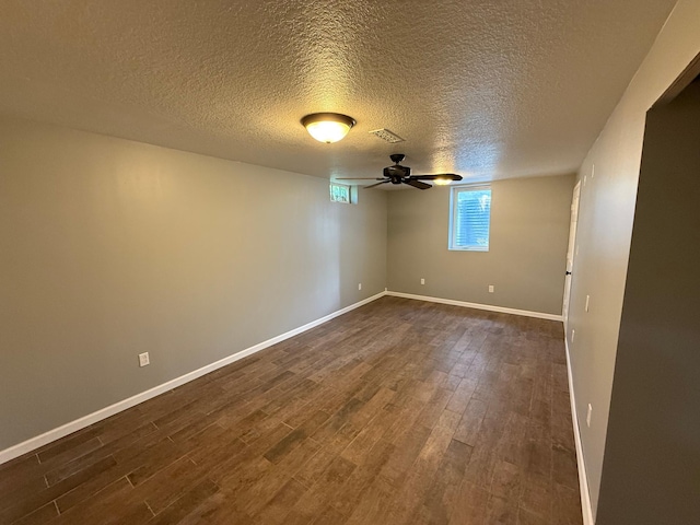 446 Darwin St, Litchfield, MN 55355 - unfurnished room with dark wood-type flooring, baseboards, a textured ceiling, and ceiling fan