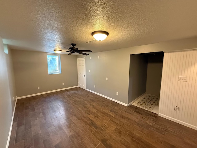 446 Darwin St, Litchfield, MN 55355 - unfurnished room with a textured ceiling, dark wood-type flooring, baseboards, and a ceiling fan