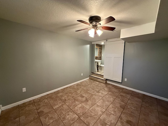 446 Darwin St, Litchfield, MN 55355 - unfurnished bedroom featuring a textured ceiling, baseboards, and ceiling fan
