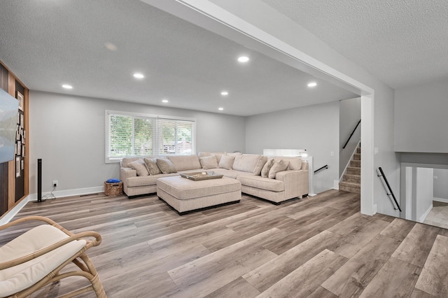 7190 Annapolis Cir, Maple Grove, MN 55311 - living area with light wood-style floors, recessed lighting, stairs, a textured ceiling, and baseboards