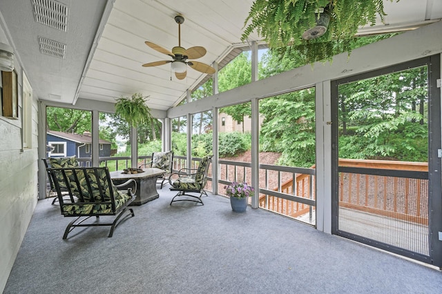 7190 Annapolis Cir, Maple Grove, MN 55311 - sunroom / solarium featuring a fire pit, a ceiling fan, healthy amount of natural light, and lofted ceiling