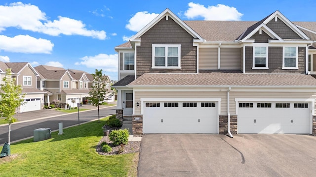 6980 Archer Trl, Inver Grove Heights, MN 55077 - view of front of property with driveway, an attached garage, a front yard, roof with shingles, and a residential view